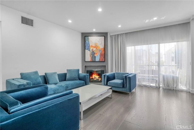 14347 Albers St Unit 207, Sherman Oaks, CA 91401 - living area featuring wood finished floors, recessed lighting, and a lit fireplace