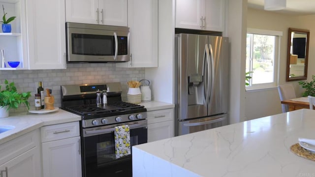 13356 Corte De Chucena, San Diego, CA 92128 - kitchen featuring appliances with stainless steel finishes, white cabinets, open shelves, and backsplash