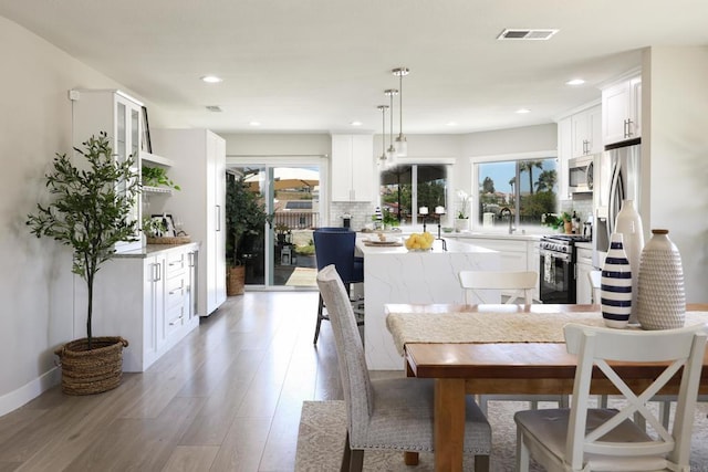 13356 Corte De Chucena, San Diego, CA 92128 - dining room with light wood finished floors, healthy amount of natural light, recessed lighting, and baseboards