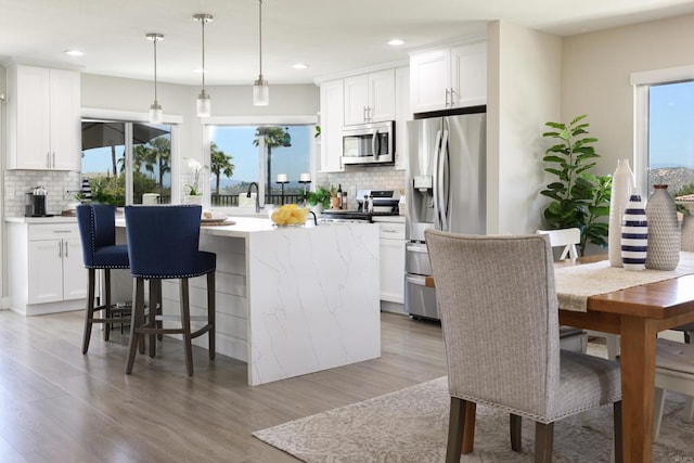 13356 Corte De Chucena, San Diego, CA 92128 - kitchen featuring appliances with stainless steel finishes, backsplash, healthy amount of natural light, and recessed lighting