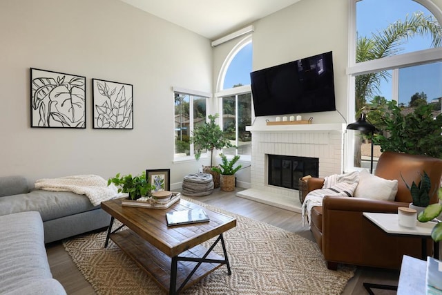13356 Corte De Chucena, San Diego, CA 92128 - living room featuring a high ceiling, a brick fireplace, and wood finished floors