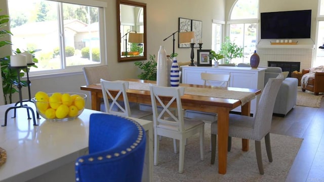13356 Corte De Chucena, San Diego, CA 92128 - dining space with a fireplace and light wood-type flooring