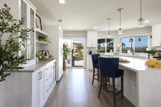 13356 Corte De Chucena, San Diego, CA 92128 - kitchen with open shelves, decorative backsplash, white cabinetry, and recessed lighting