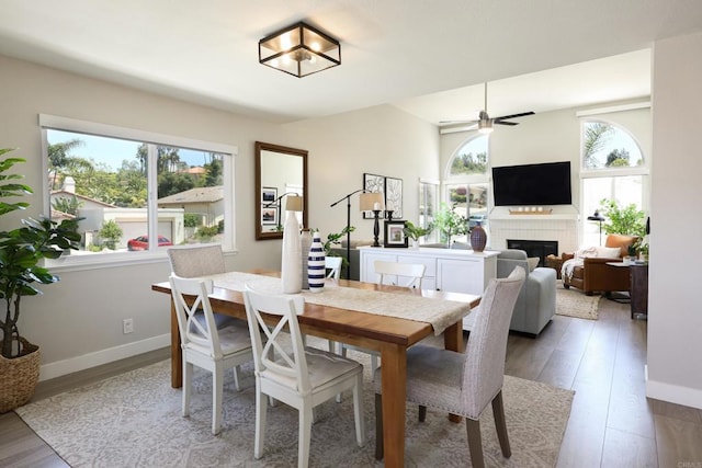 13356 Corte De Chucena, San Diego, CA 92128 - dining room with a brick fireplace, wood finished floors, baseboards, and ceiling fan