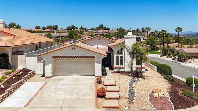 13356 Corte De Chucena, San Diego, CA 92128 - mediterranean / spanish-style house featuring driveway, a garage, stucco siding, and a tile roof