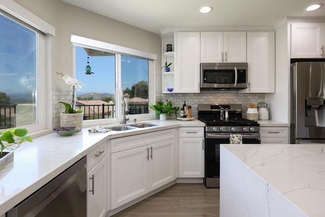 13356 Corte De Chucena, San Diego, CA 92128 - kitchen with stainless steel appliances, recessed lighting, white cabinets, backsplash, and open shelves