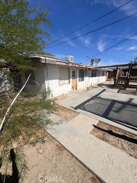 84673 9th St, Trona, CA 93562 - back of house with a patio, stucco siding, and central air condition unit