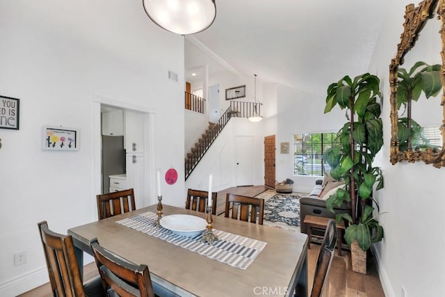 167 Camino Leon, Camarillo, CA 93012 - dining area with stairway, baseboards, high vaulted ceiling, and wood finished floors