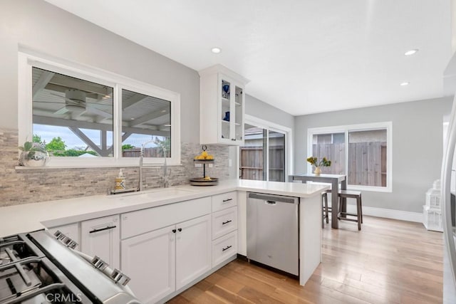 167 Camino Leon, Camarillo, CA 93012 - kitchen with dishwasher, a sink, decorative backsplash, light wood-style flooring, and white cabinets