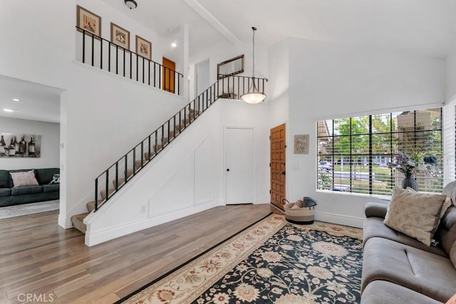 167 Camino Leon, Camarillo, CA 93012 - living room with high vaulted ceiling, wood finished floors, baseboards, and stairway