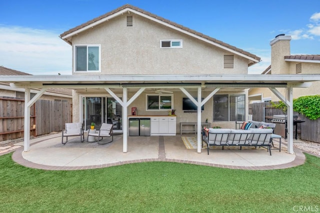 167 Camino Leon, Camarillo, CA 93012 - back of property with stucco siding, a patio area, outdoor lounge area, an outdoor kitchen, and ceiling fan