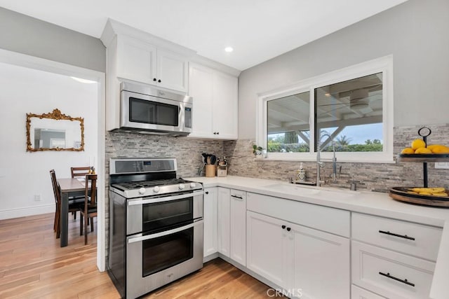 167 Camino Leon, Camarillo, CA 93012 - kitchen featuring appliances with stainless steel finishes, tasteful backsplash, white cabinets, light countertops, and a sink