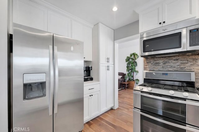 167 Camino Leon, Camarillo, CA 93012 - kitchen featuring stainless steel appliances, decorative backsplash, light wood-style floors, white cabinetry, and recessed lighting