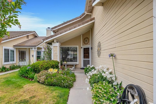167 Camino Leon, Camarillo, CA 93012 - view of exterior entry with a chimney and a lawn