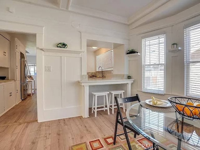 25 W Walnut St, Stockton, CA 95204 - dining space with light wood-style floors, healthy amount of natural light, and ornamental molding