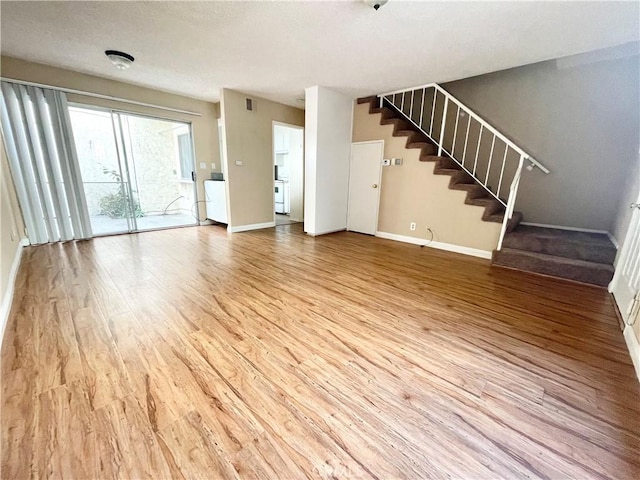 220 N Alhambra Ave Unit B, Monterey Park, CA 91755 - unfurnished living room with stairs, baseboards, and light wood-style floors