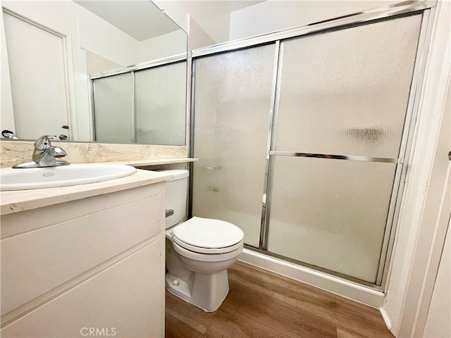 220 N Alhambra Ave Unit B, Monterey Park, CA 91755 - bathroom featuring wood finished floors, a stall shower, toilet, and vanity