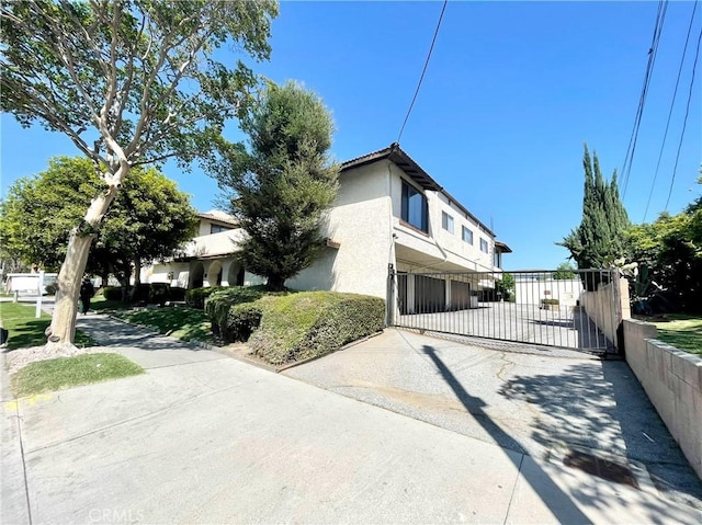 220 N Alhambra Ave Unit B, Monterey Park, CA 91755 - view of property exterior with a gate, stucco siding, and driveway