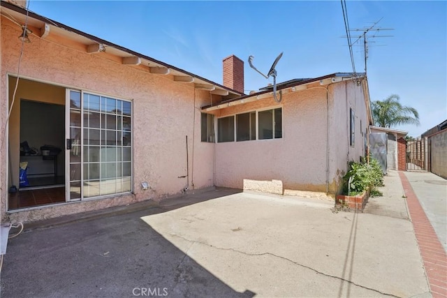 14276 Aztec St, Sylmar, CA 91342 - back of house featuring a patio, stucco siding, and a chimney