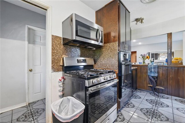 14276 Aztec St, Sylmar, CA 91342 - kitchen with appliances with stainless steel finishes, light tile patterned flooring, and decorative backsplash