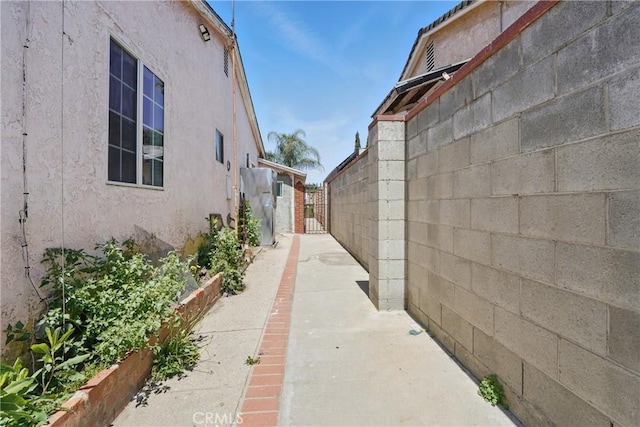 14276 Aztec St, Sylmar, CA 91342 - view of side of home with stucco siding and a patio