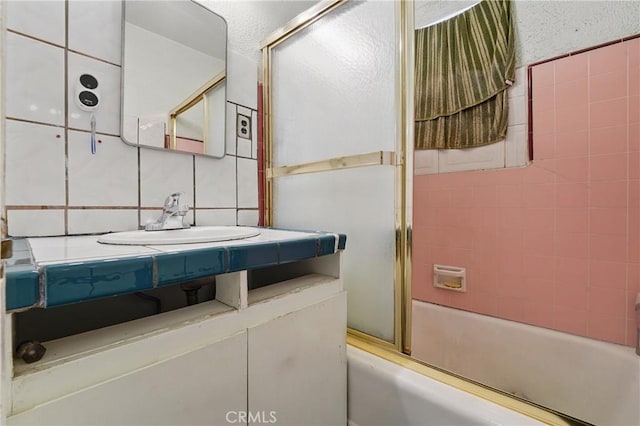 14276 Aztec St, Sylmar, CA 91342 - full bathroom with vanity, bath / shower combo with glass door, and tasteful backsplash