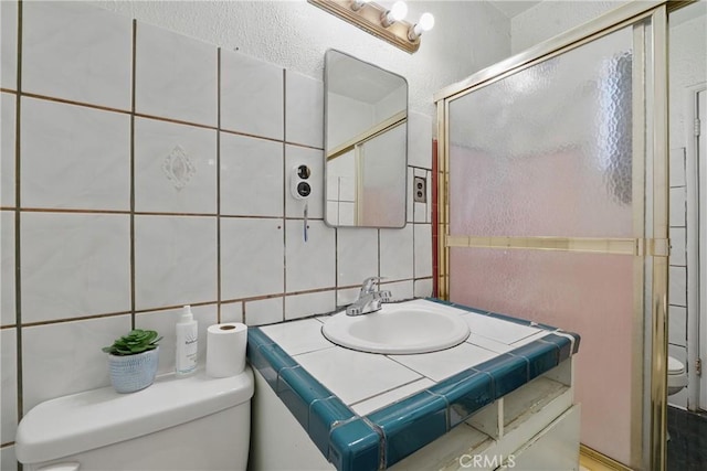 14276 Aztec St, Sylmar, CA 91342 - full bath featuring toilet, backsplash, a shower stall, vanity, and tile walls