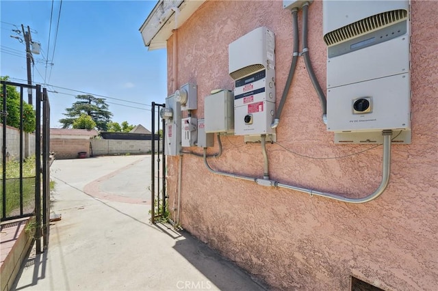14276 Aztec St, Sylmar, CA 91342 - exterior view of related energy utilities, stucco siding, and a gate