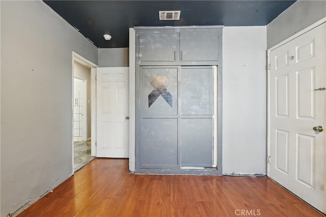 14276 Aztec St, Sylmar, CA 91342 - unfurnished bedroom featuring wood finished floors and a closet