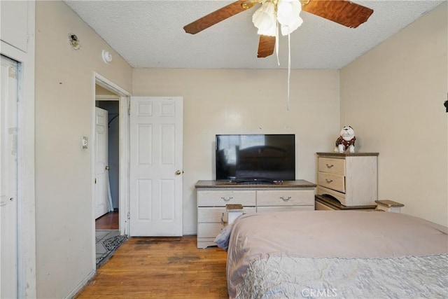 14276 Aztec St, Sylmar, CA 91342 - bedroom featuring wood finished floors, a textured ceiling, and a ceiling fan