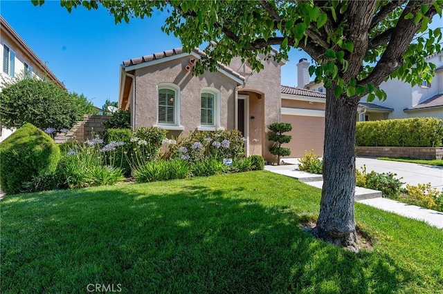 19613 Edmonds Pl, Saugus, CA 91350 - mediterranean / spanish-style house featuring a front yard, stucco siding, a tile roof, concrete driveway, and an attached garage