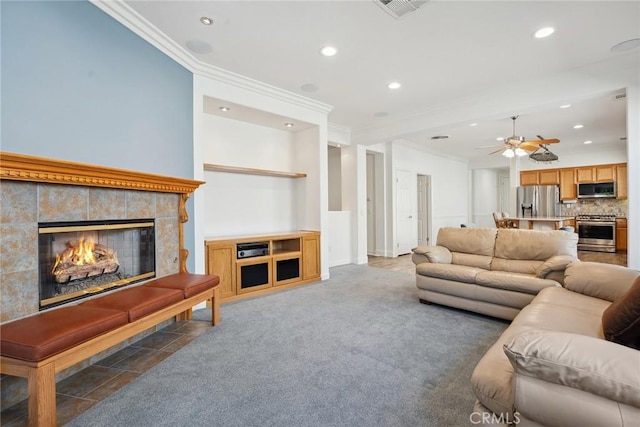 19613 Edmonds Pl, Saugus, CA 91350 - living room featuring ornamental molding, recessed lighting, ceiling fan, a tile fireplace, and light carpet