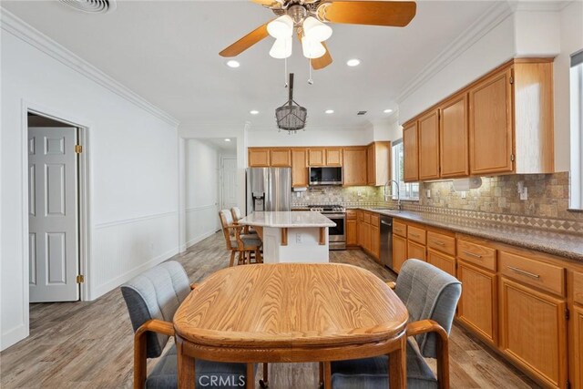 19613 Edmonds Pl, Saugus, CA 91350 - dining area featuring ornamental molding, a ceiling fan, light wood-style floors, and recessed lighting