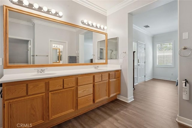 19613 Edmonds Pl, Saugus, CA 91350 - bathroom featuring double vanity, wood finished floors, and crown molding