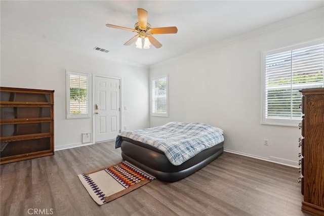 19613 Edmonds Pl, Saugus, CA 91350 - bedroom with wood finished floors, multiple windows, ornamental molding, and ceiling fan