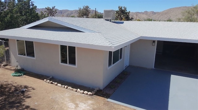 55650 Navajo Trl, Yucca Valley, CA 92284 - view of side of home with stucco siding and a mountain view