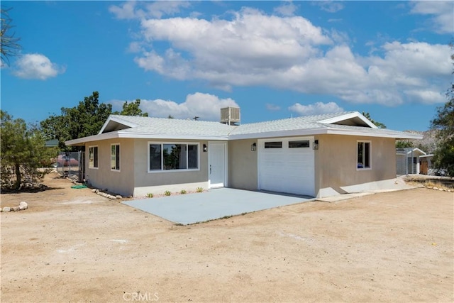 55650 Navajo Trl, Yucca Valley, CA 92284 - single story home featuring stucco siding, an attached garage, central AC, and driveway