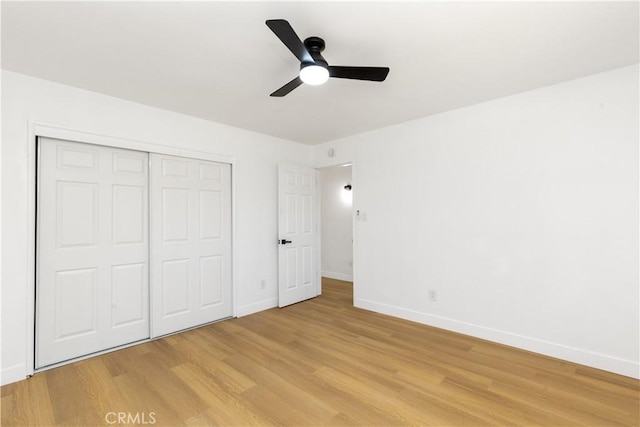 55650 Navajo Trl, Yucca Valley, CA 92284 - unfurnished bedroom with baseboards, light wood-type flooring, a closet, and a ceiling fan