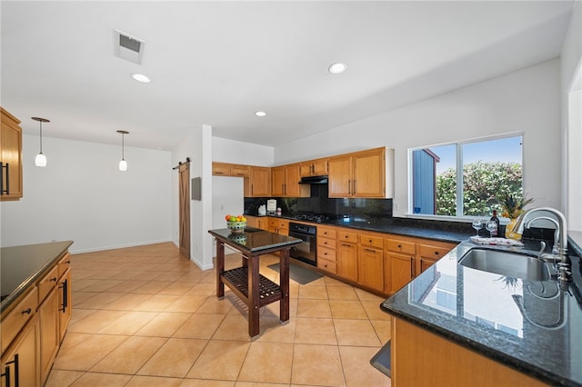 29083 Bent Tree Dr, Murrieta, CA 92563 - kitchen featuring black appliances, a sink, under cabinet range hood, pendant lighting, and dark stone counters