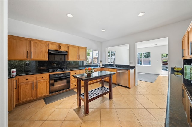 29083 Bent Tree Dr, Murrieta, CA 92563 - kitchen with black oven, stainless steel dishwasher, under cabinet range hood, gas stovetop, and tasteful backsplash