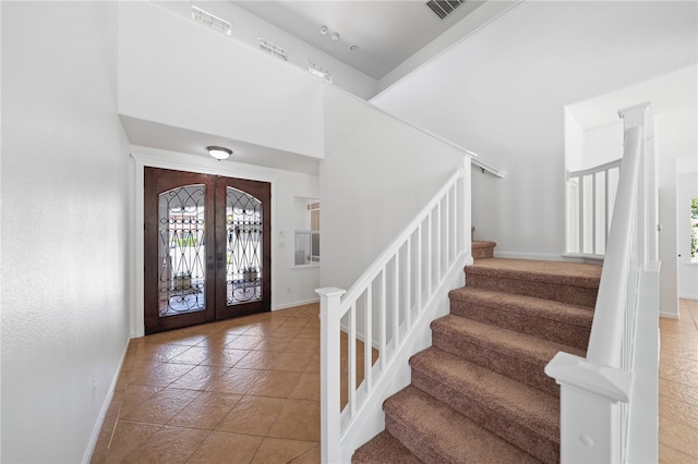 29083 Bent Tree Dr, Murrieta, CA 92563 - foyer entrance featuring baseboards, french doors, stairway, tile patterned flooring, and a high ceiling