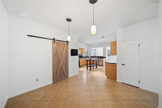 29083 Bent Tree Dr, Murrieta, CA 92563 - kitchen with a barn door, dishwasher, light tile patterned flooring, recessed lighting, and baseboards