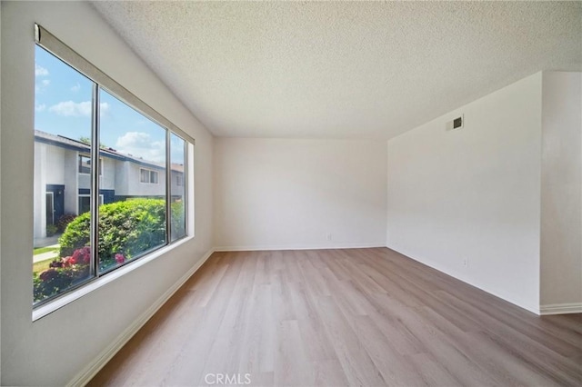 1926 Lucas St Unit 2, San Fernando, CA 91340 - unfurnished room featuring wood finished floors, a textured ceiling, and baseboards