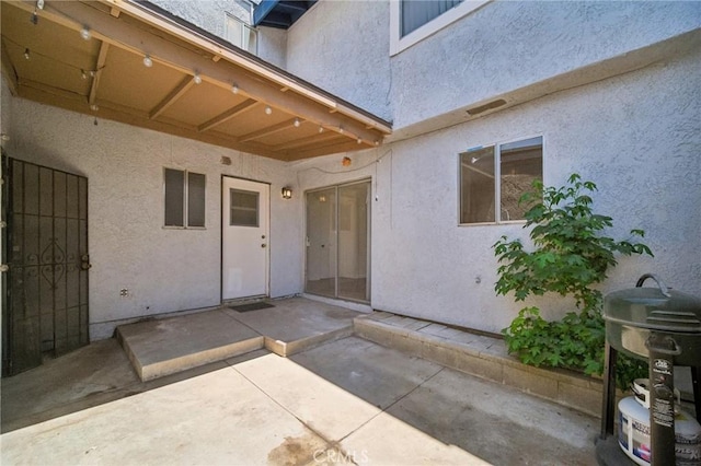 1926 Lucas St Unit 2, San Fernando, CA 91340 - view of exterior entry featuring stucco siding and a patio area