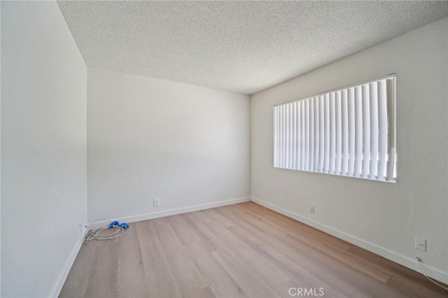 1926 Lucas St Unit 2, San Fernando, CA 91340 - spare room featuring wood finished floors, a textured ceiling, and baseboards