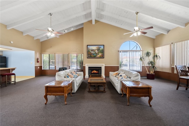 43195 Andrade Ave Unit L, Hemet, CA 92544 - carpeted living room with ceiling fan, wood ceiling with exposed beams, high vaulted ceiling, and a lit fireplace