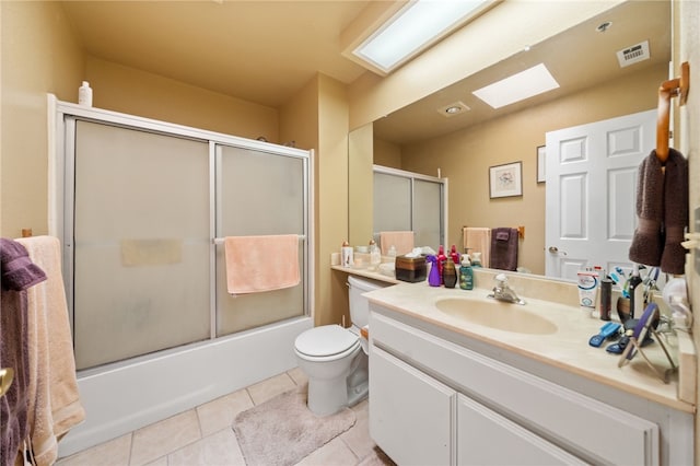 43195 Andrade Ave Unit L, Hemet, CA 92544 - full bathroom with a skylight, vanity, tile patterned floors, toilet, and combined bath / shower with glass door