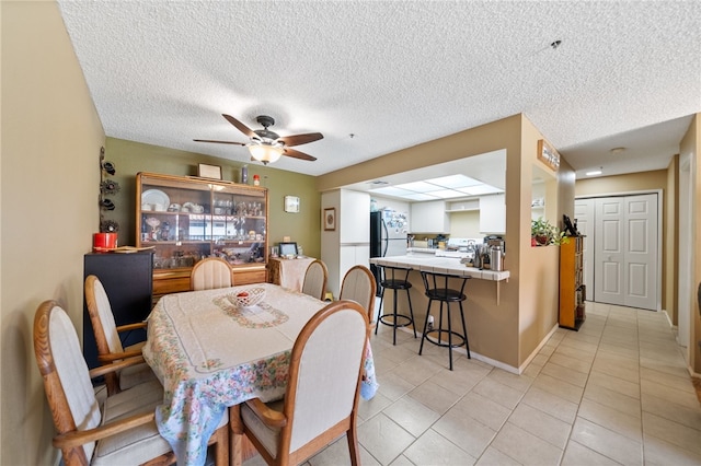43195 Andrade Ave Unit L, Hemet, CA 92544 - dining room featuring ceiling fan, light tile patterned floors, a textured ceiling, and baseboards