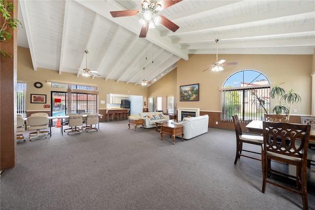 43195 Andrade Ave Unit L, Hemet, CA 92544 - carpeted living room with ceiling fan, high vaulted ceiling, wood ceiling with exposed beams, and a lit fireplace