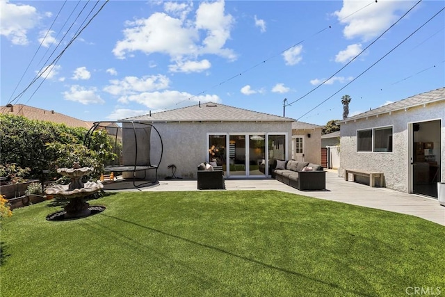 1156 W 26th St, San Pedro, CA 90731 - back of house with stucco siding, outdoor lounge area, a patio, and a trampoline